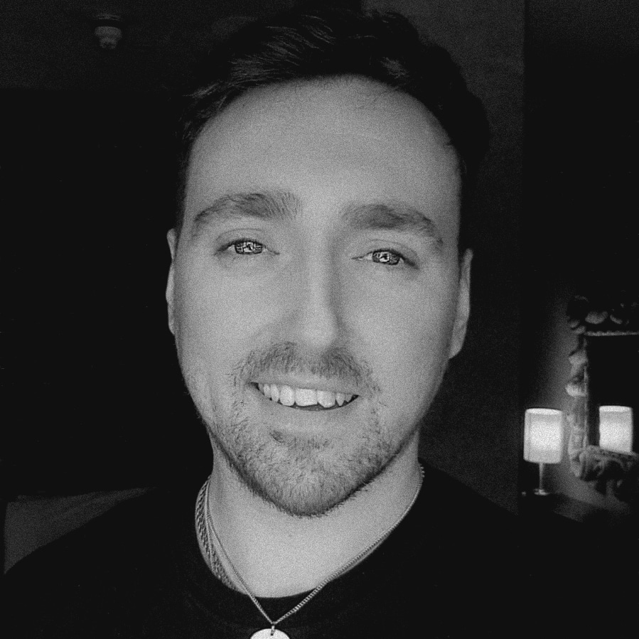 Life Optimisation Coach, Jake McCullough, in a black and white portrait photograph.